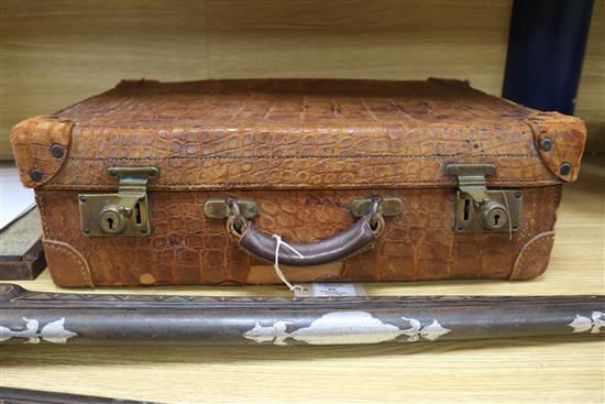 An early 20th century crocodile skin briefcase and a suitcase length 49cm